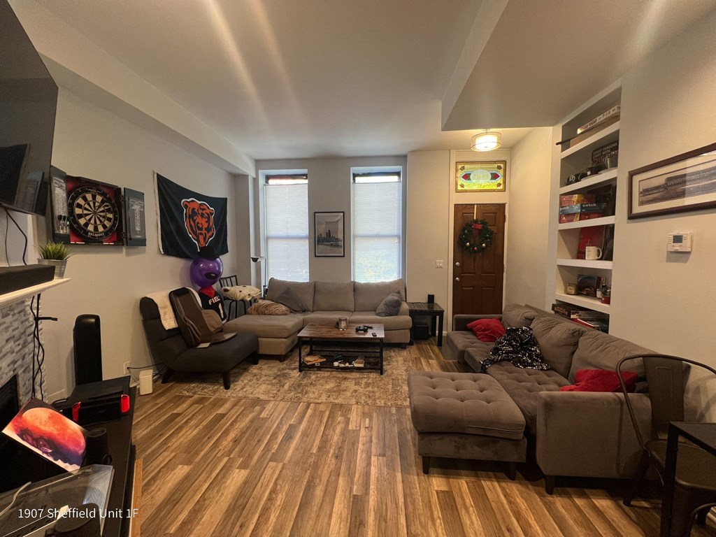 a living room with couches and chairs and a tv