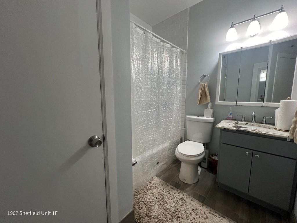 a bathroom with a shower and a toilet and a sink