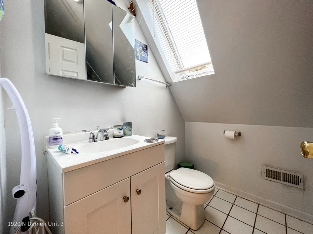 a bathroom with a sink toilet and a mirror