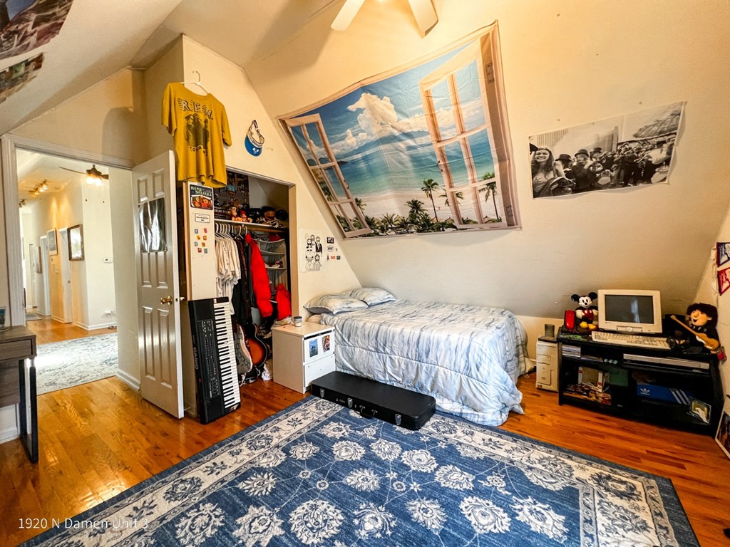 a bedroom with a bed and a dresser and a closet