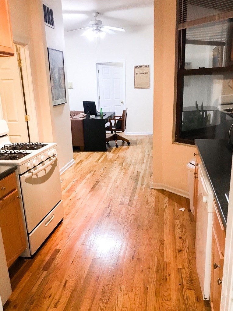 the view from the kitchen into the living room and the dining room