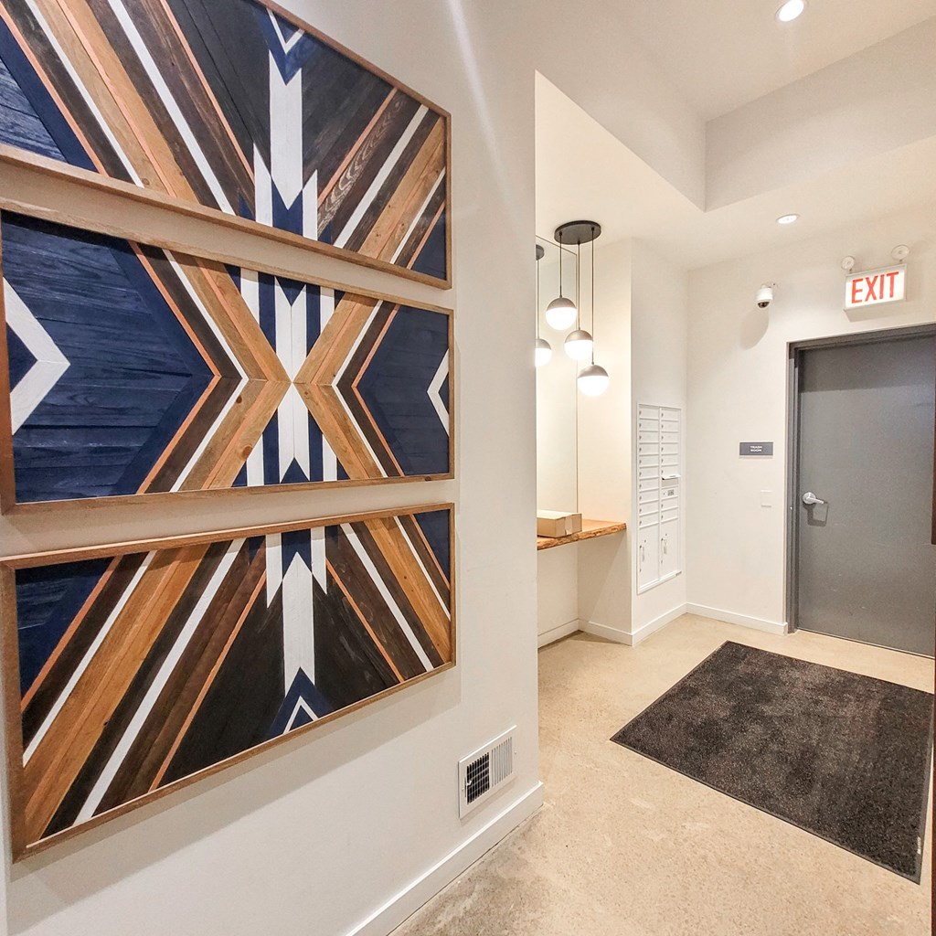 a hallway with a large painting on the wall