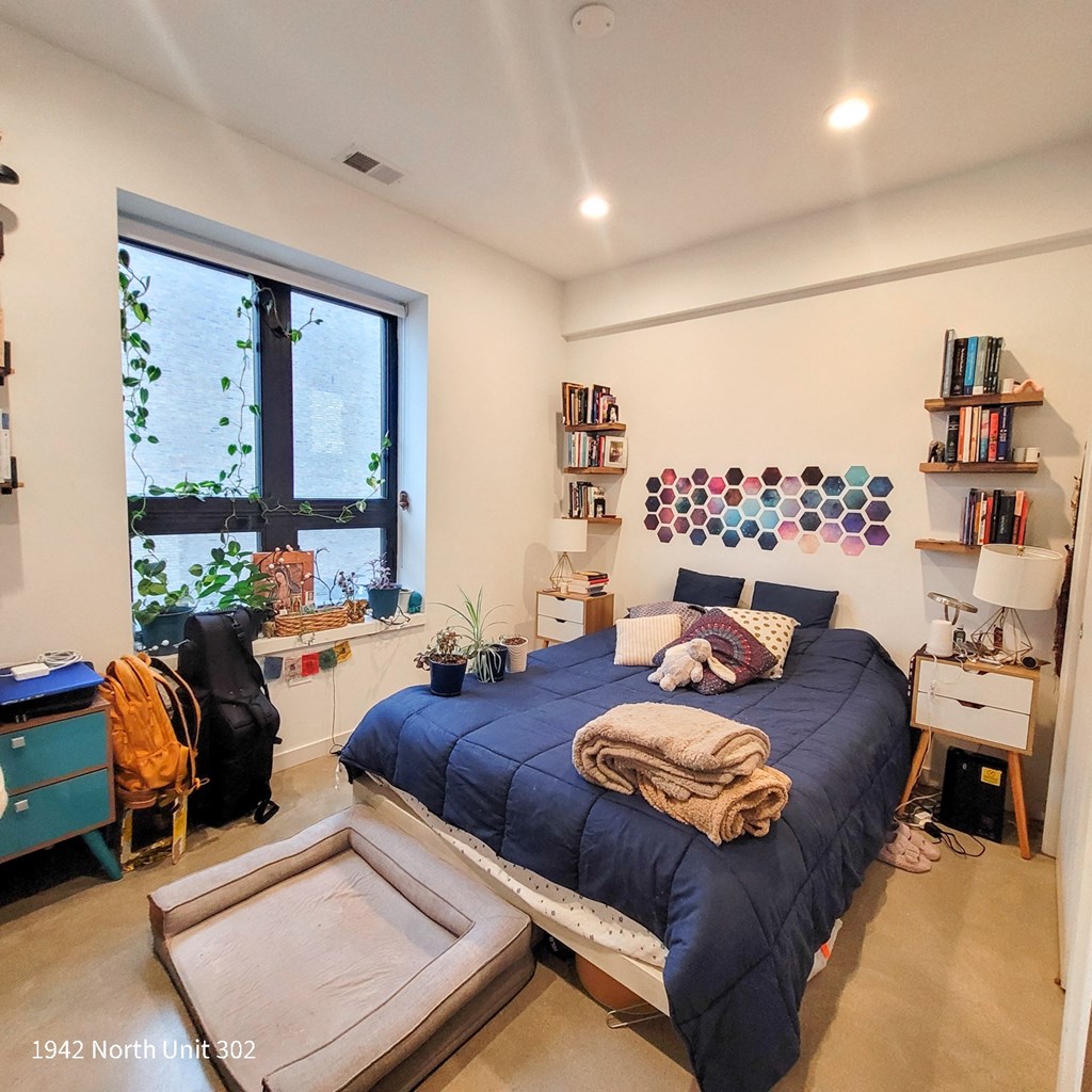 a bedroom with a bed and a window