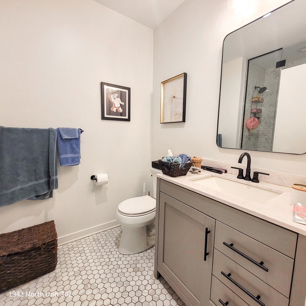 a bathroom with a sink toilet and a mirror