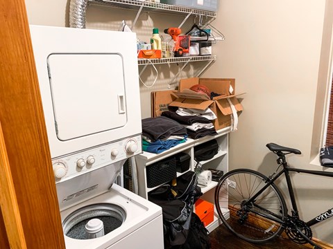 A bicycle is leaning against a wall in a small, cluttered room.