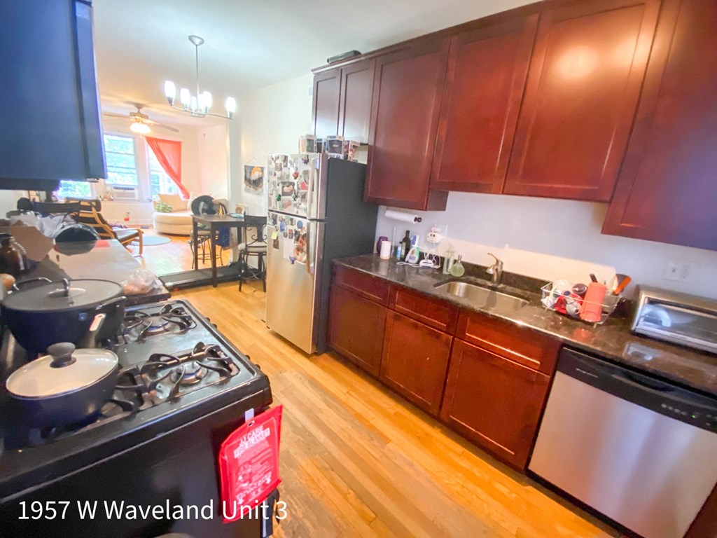 a kitchen with a stove and a sink and a refrigerator
