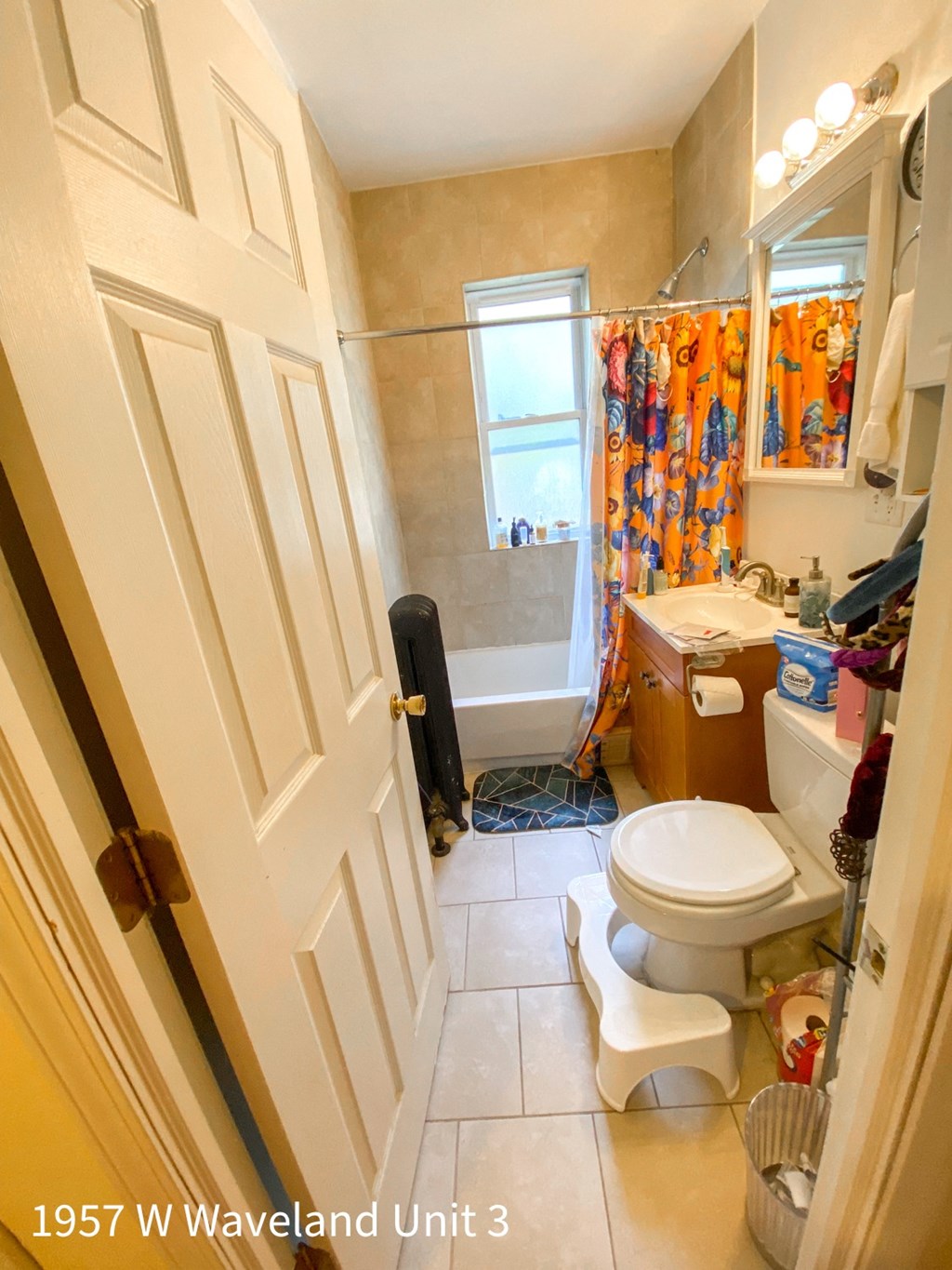 a small bathroom with a toilet and a sink and a shower