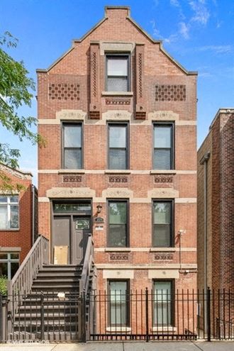 a brick building with a staircase in front of it