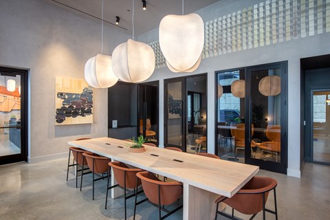 A conference room with a long table and chairs.