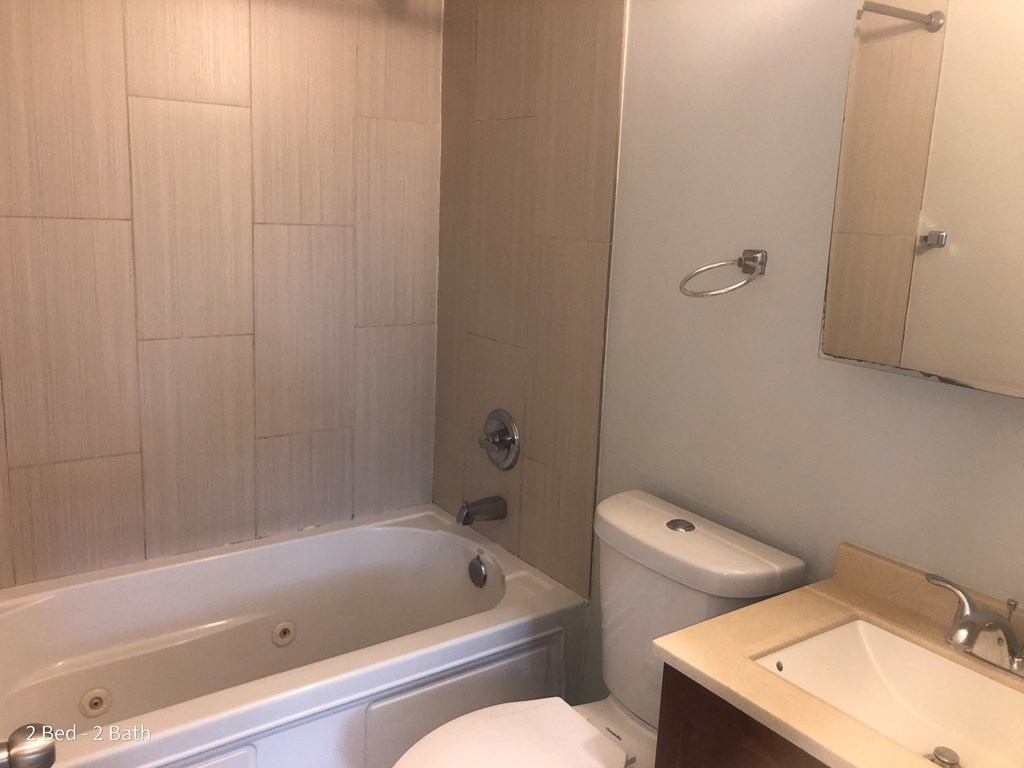 a bathroom with a sink toilet and a bath tub