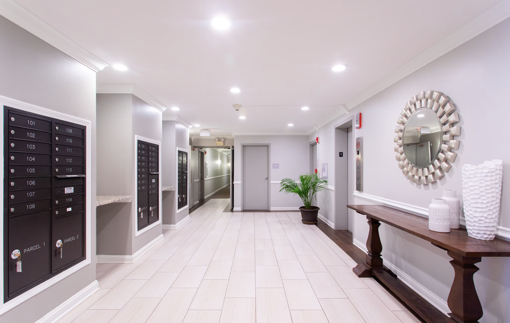 the hallway of a locker room in a gym with a mirror on the wall