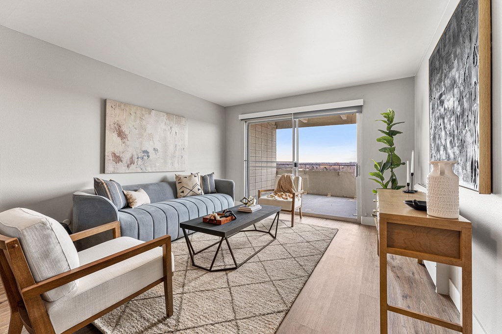 an spacious and open living room with a sliding glass door to a balcony
