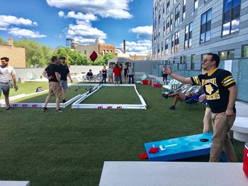 People playing games at the sun deck at L Logan Square