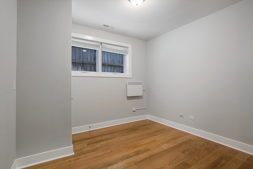 A room with a window and a radiator on the wall.