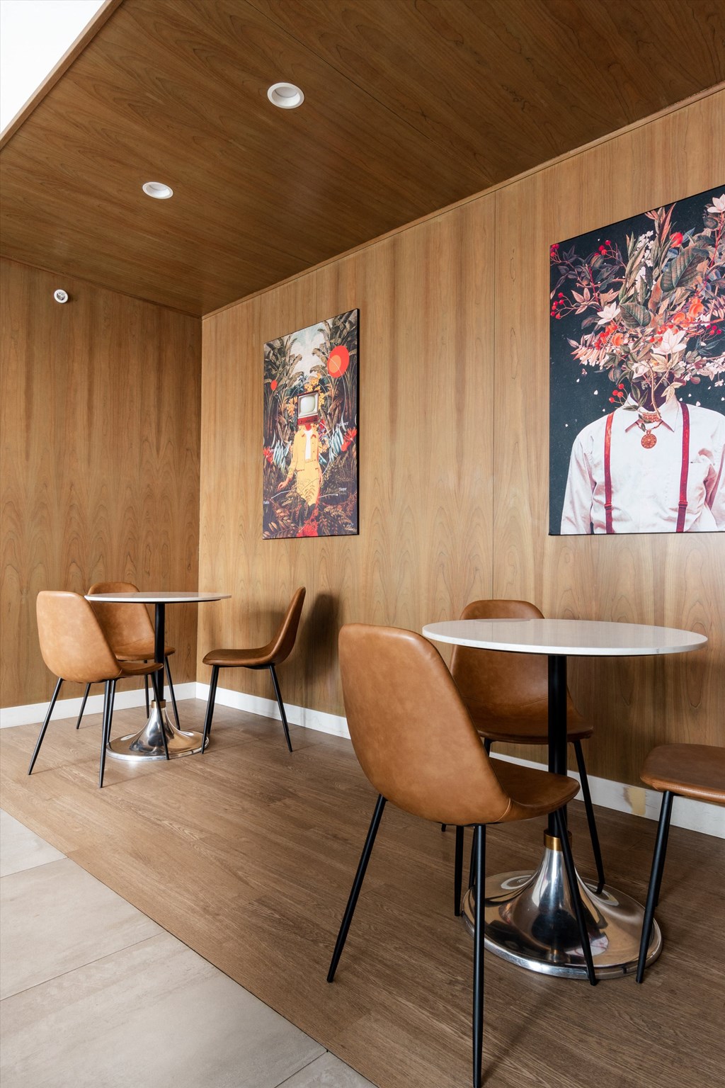 a room with wooden walls and two paintings on the wall