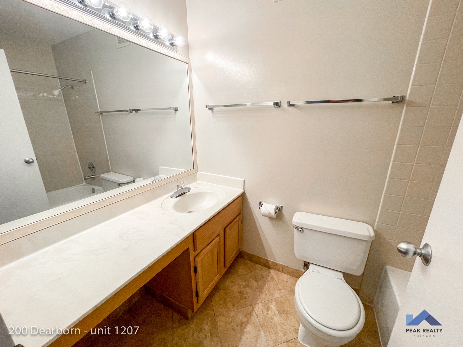 a bathroom with a toilet and a sink and a large mirror