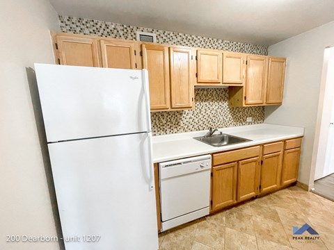a kitchen with white appliances and wooden cabinets