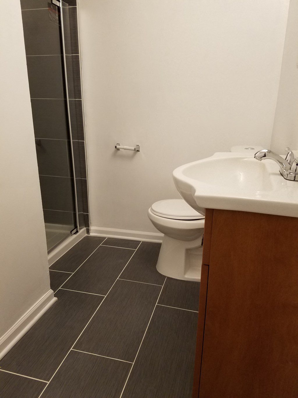 a small bathroom with a sink toilet and shower