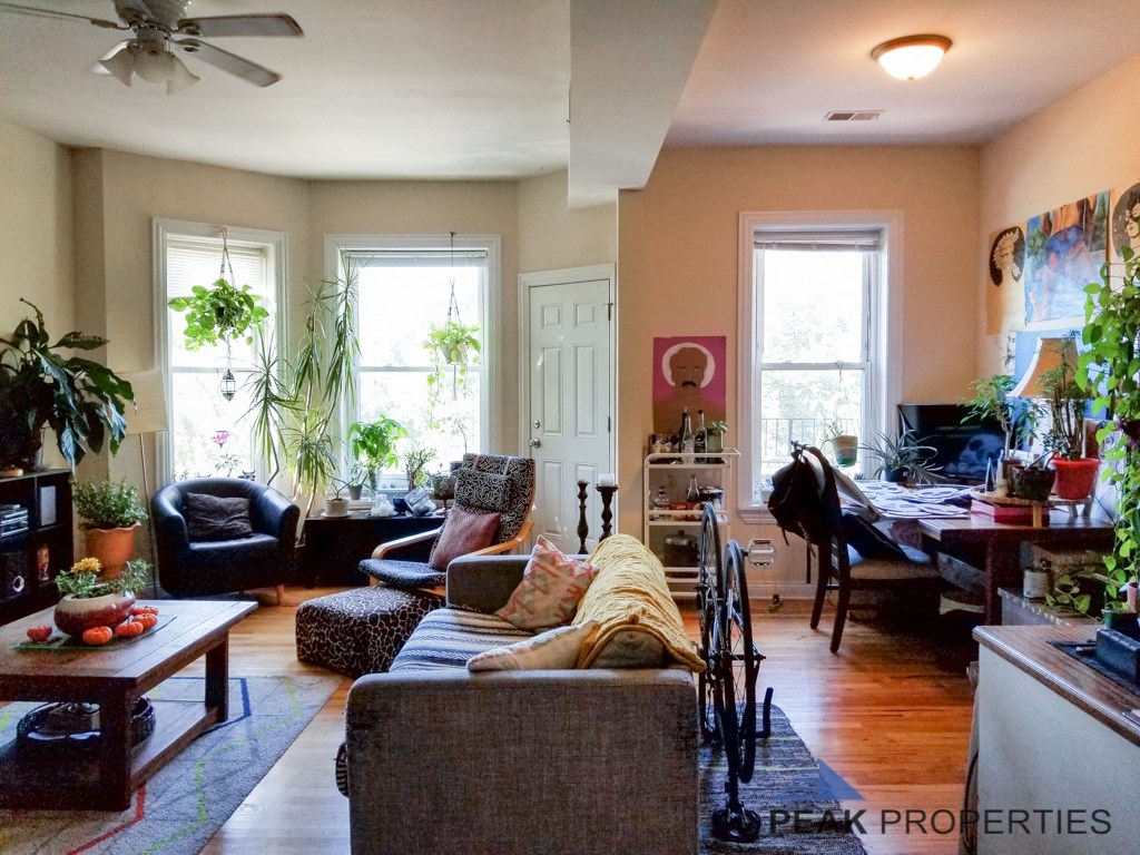 a living room filled with furniture and a dining room table