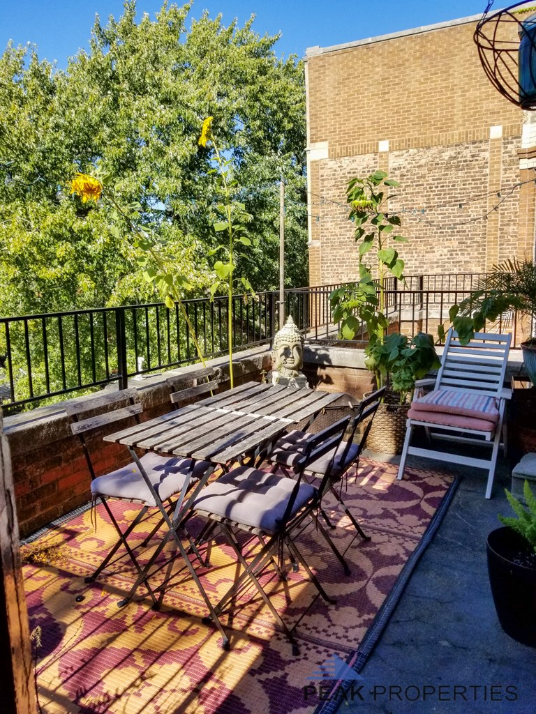 a patio with a table and chairs on a balcony