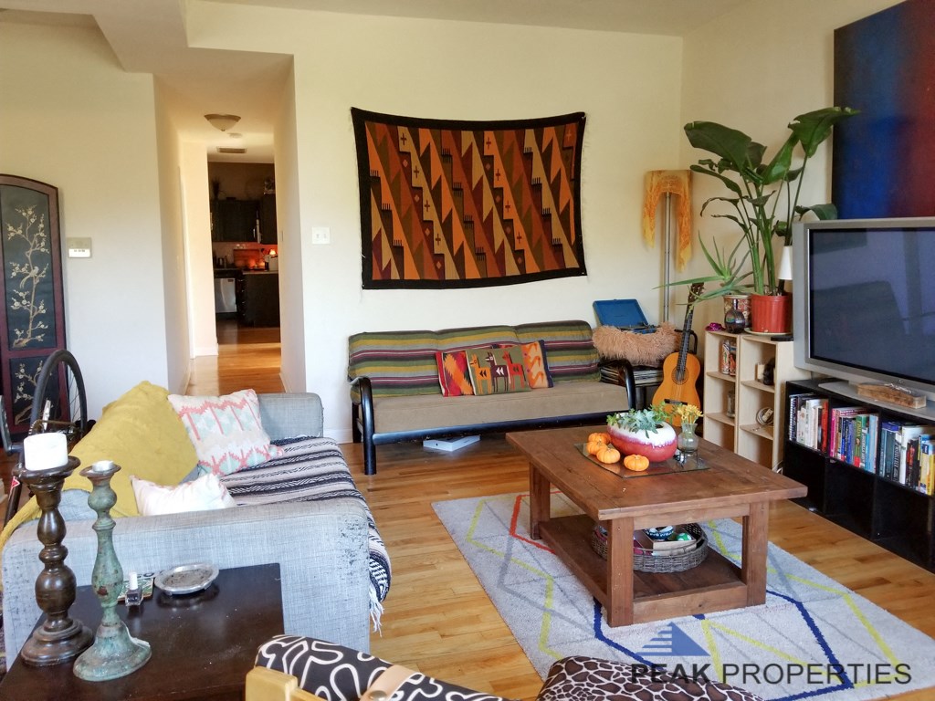 a living room filled with furniture and a tv