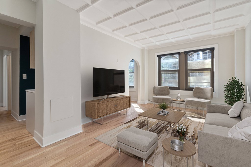 a living room with hardwood floors and white walls