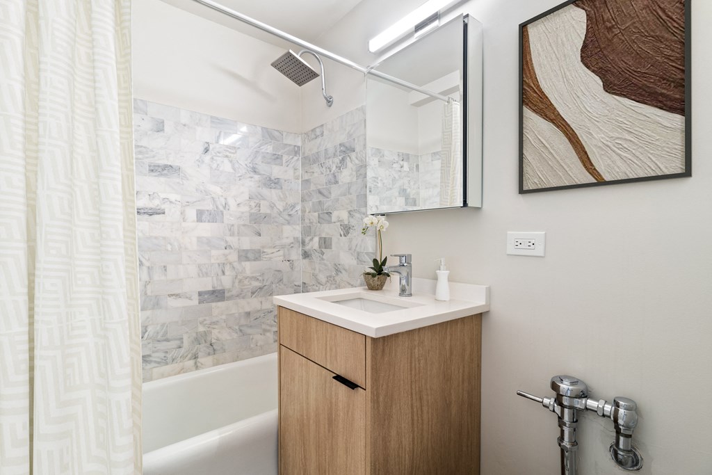 a bathroom with a sink and a bathtub in a 555 waverly unit