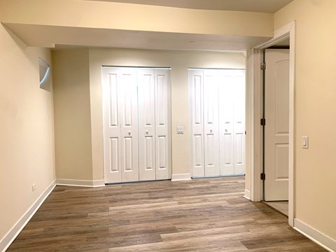 a living room with wood floors and white doors