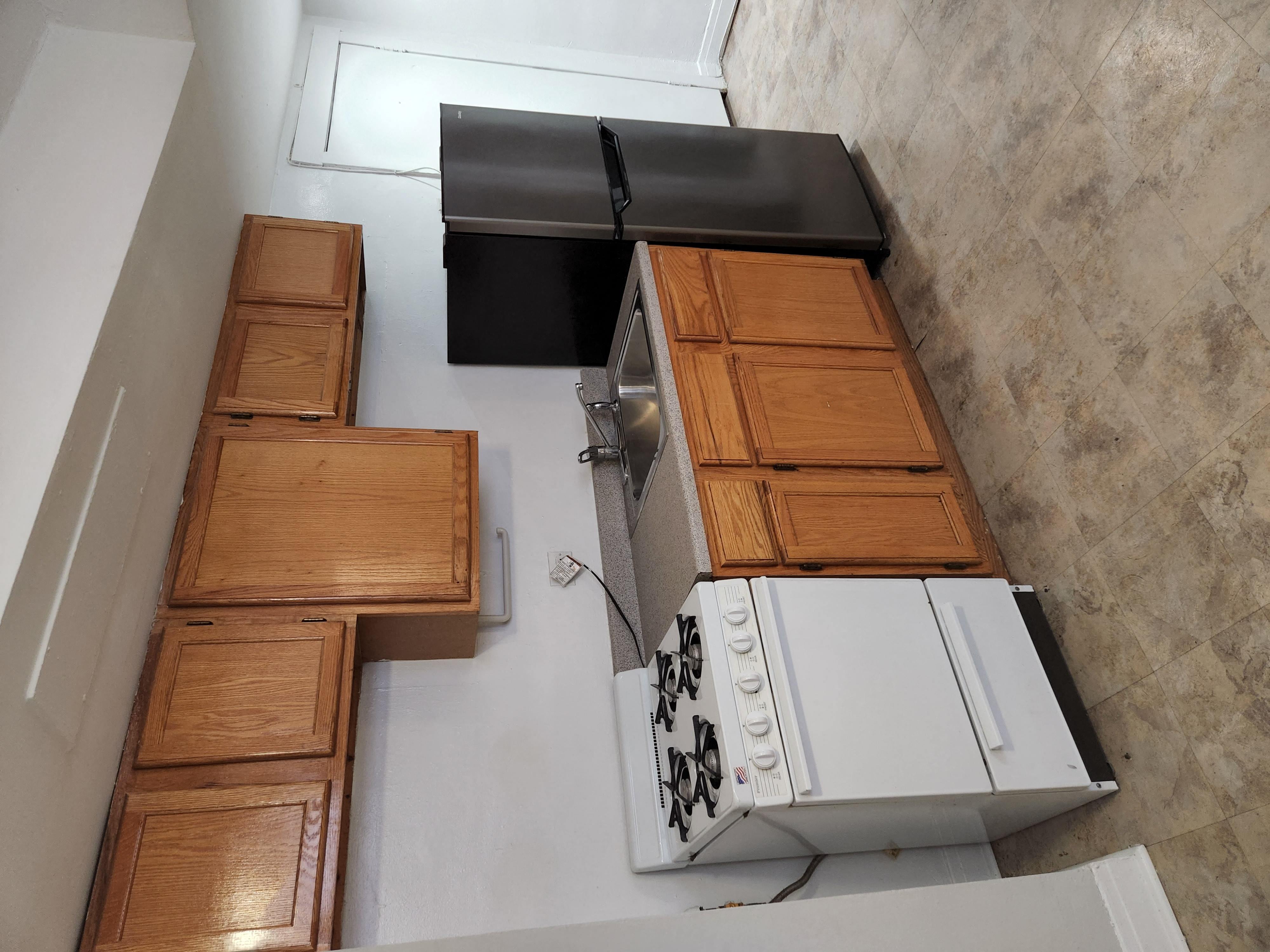 an overhead view of a kitchen with a stove and cabinets