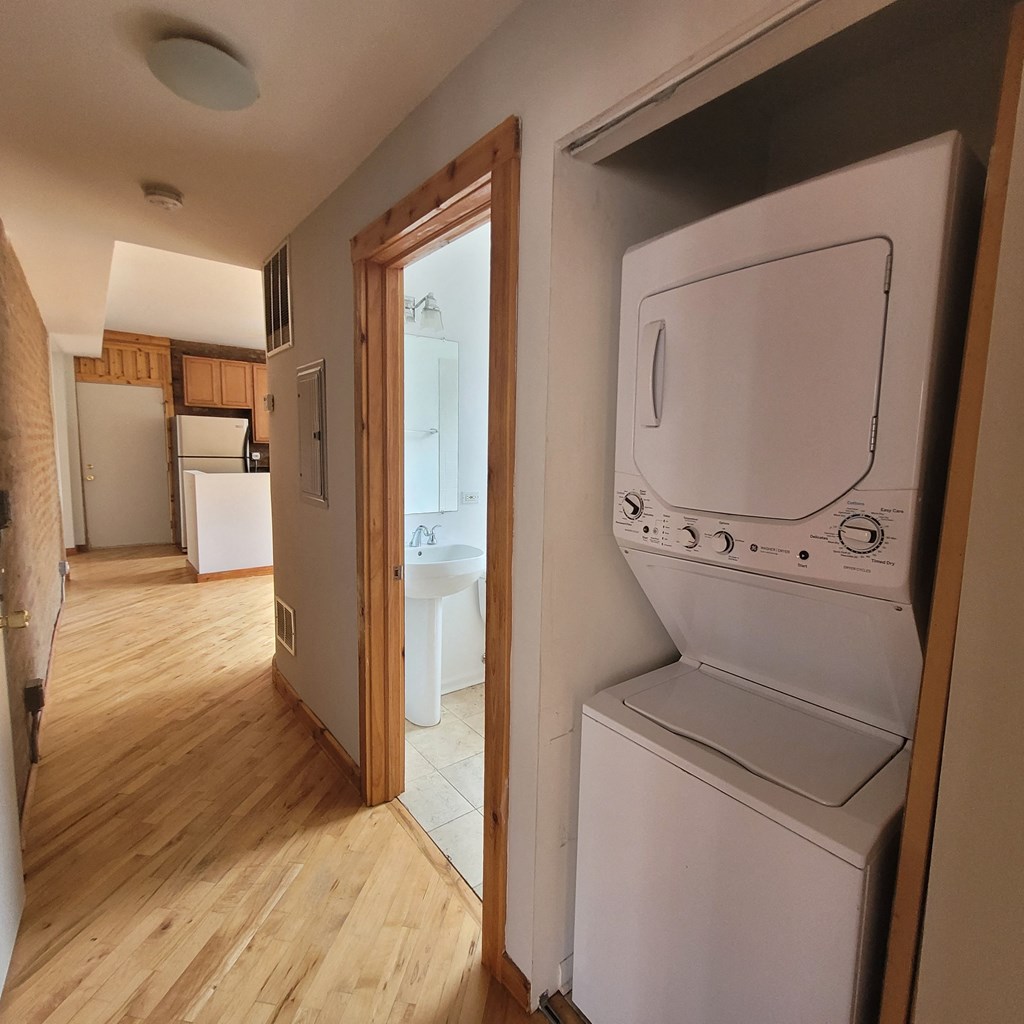 an empty laundry room with a washer and dryer in it