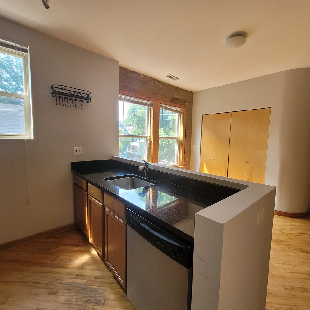 an empty kitchen with a sink and a window