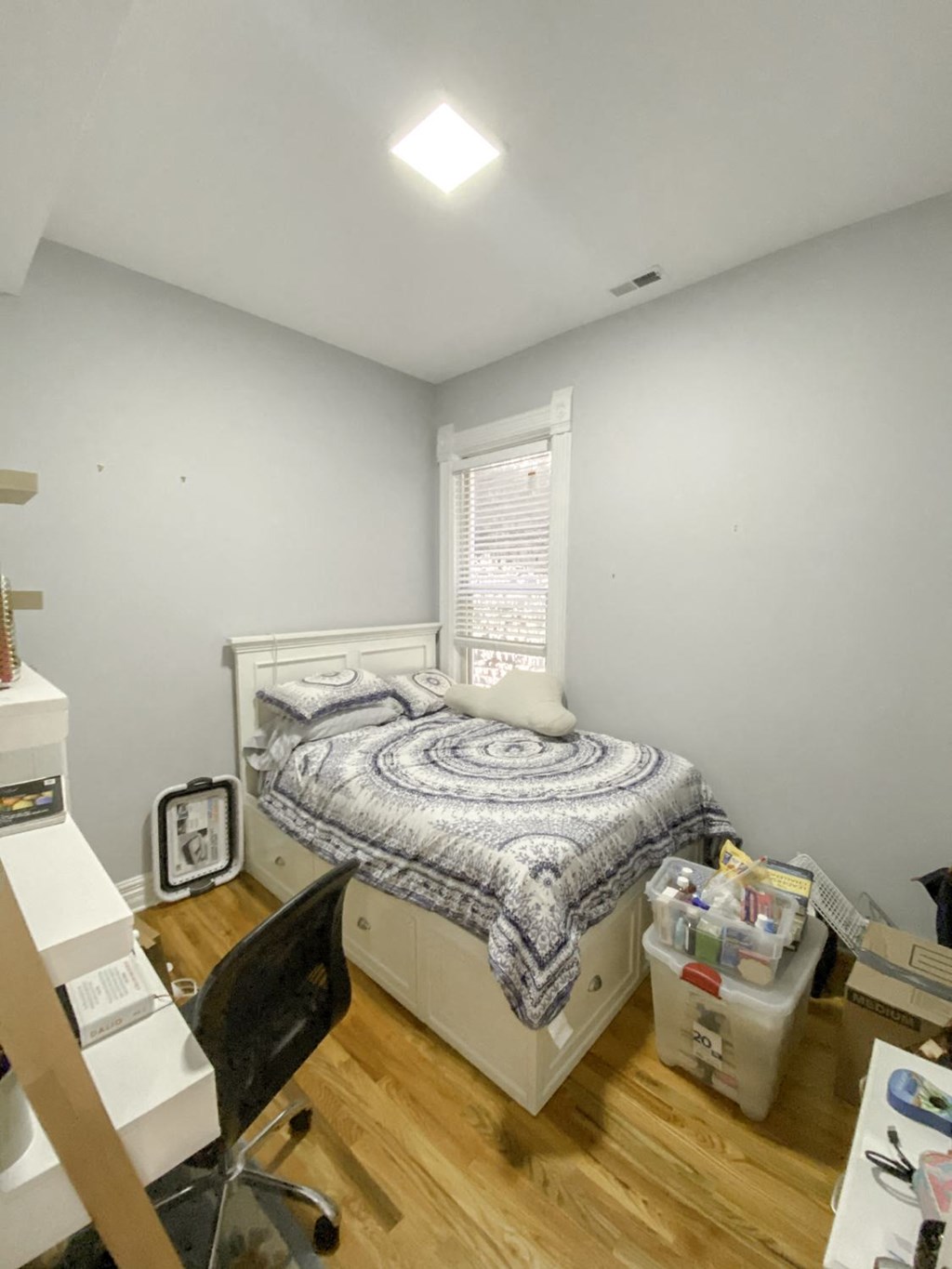 a small bedroom with a bed and a window