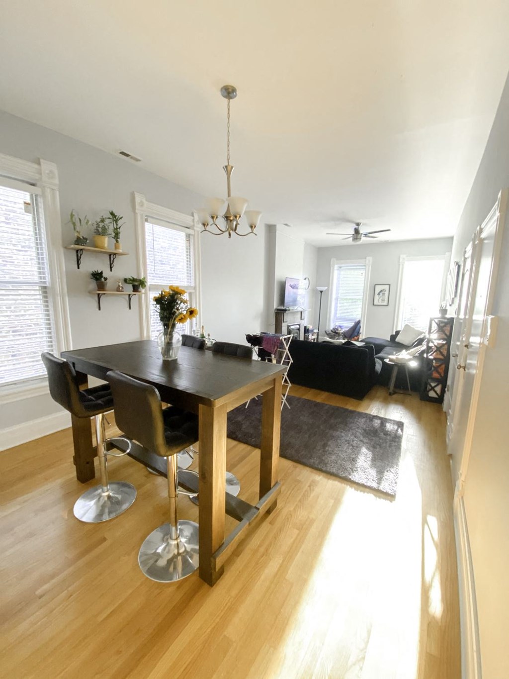 a dining room and living room with a table and chairs