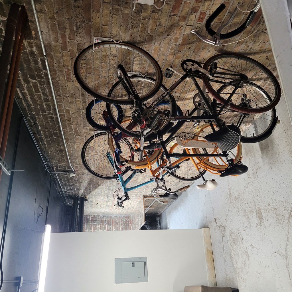 a row of bikes hanging from a ceiling in a room