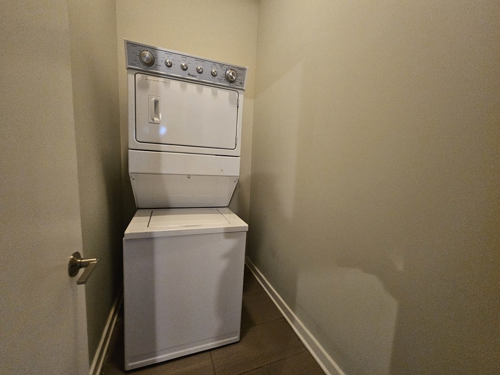 A white oven with a door open is in a room with a door to the left.