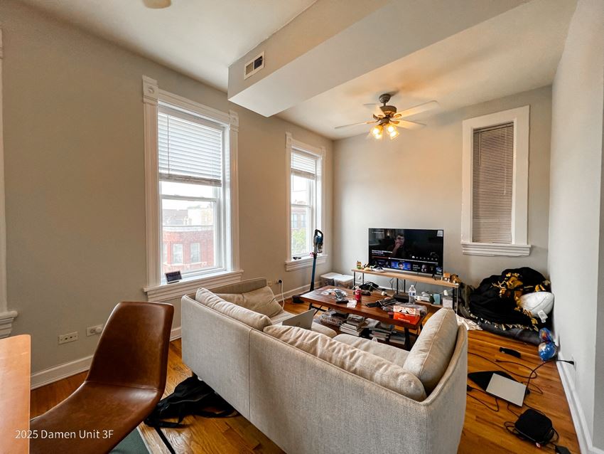 a living room with a couch and a coffee table in front of a flat screen tv