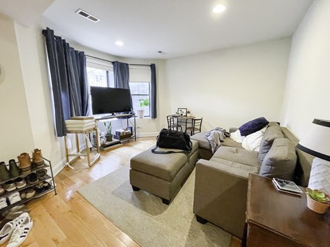 A living room with a grey couch and a television.
