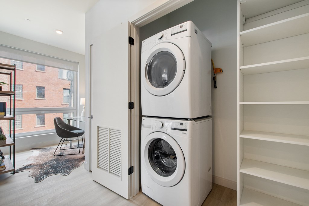 a washer and dryer are stacked on top of each other in a laundry room