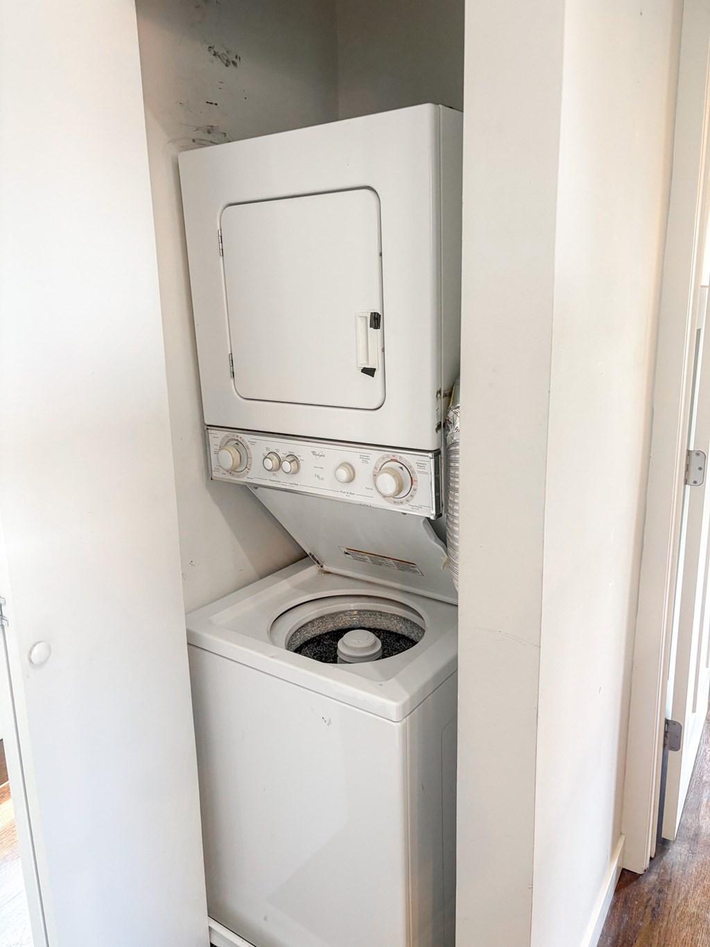 A white oven with a door open is in a room.