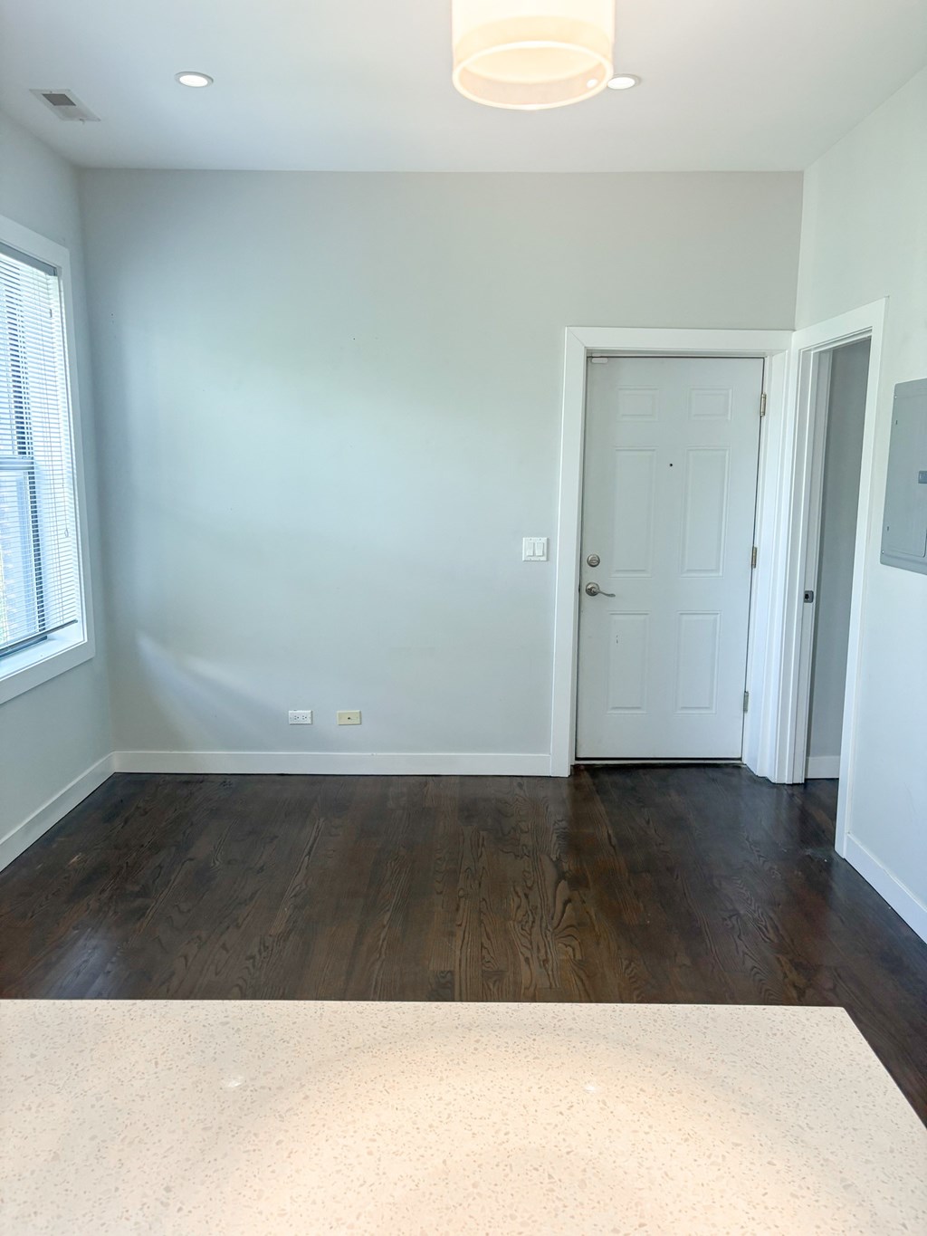 A room with a white door and a window.