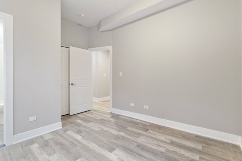 an empty room with white walls and a door