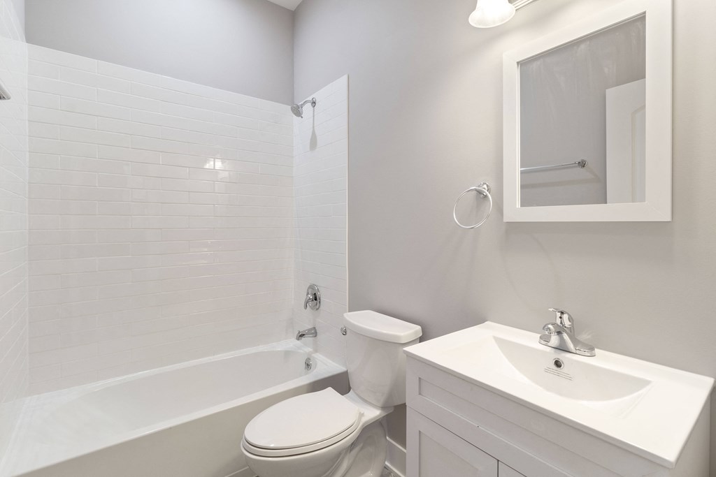 a white bathroom with a toilet sink and tub