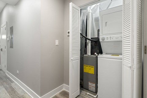 a small laundry room with a washer and dryer in it and a closet