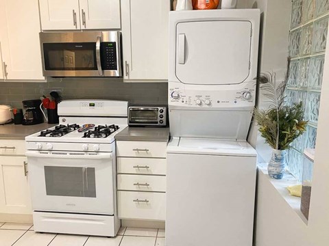 A white oven and microwave in a kitchen.