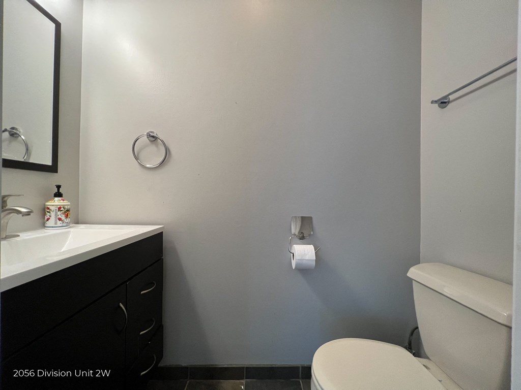 a bathroom with a toilet and a sink and a mirror