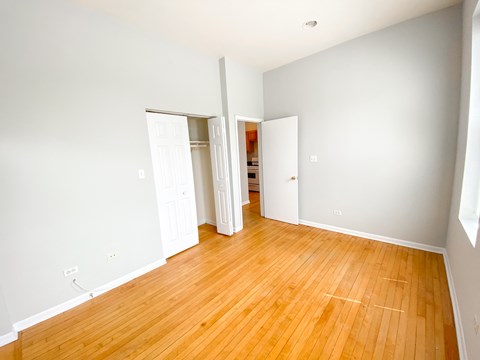 A room with a wooden floor and white walls.