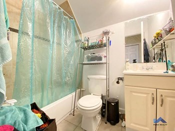 a bathroom with a toilet a sink and a shower - Photo Gallery 7