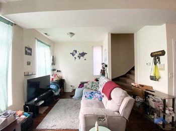 a living room filled with furniture and a flat screen tv