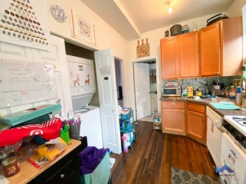 a kitchen with a refrigerator freezer next to a stove top oven