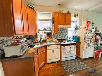 a kitchen with wooden cabinets and white appliances